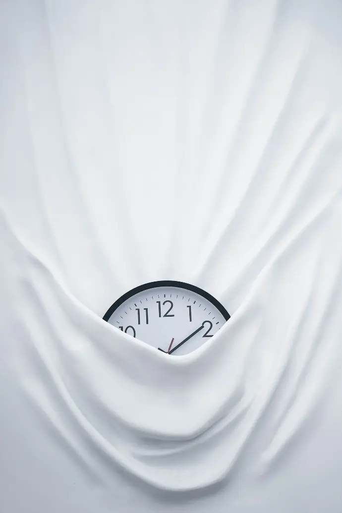 round black clock on linen